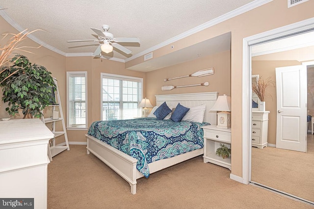 bedroom with ceiling fan, crown molding, light colored carpet, and a textured ceiling