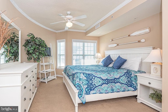 bedroom featuring ornamental molding, light carpet, ceiling fan, and a textured ceiling