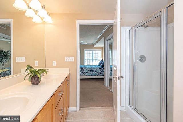 bathroom with vanity, an enclosed shower, tile patterned flooring, and a textured ceiling