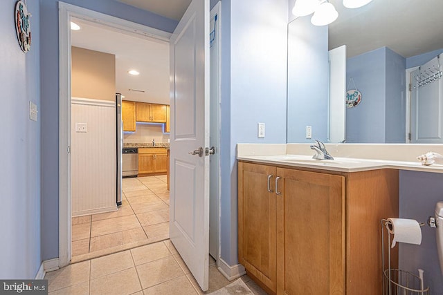 bathroom featuring tile patterned flooring and vanity