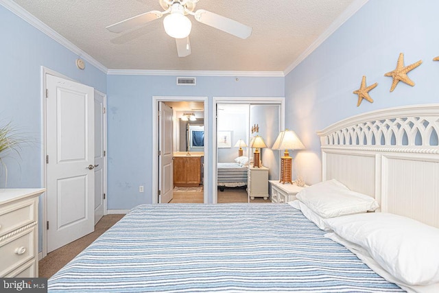 bedroom featuring ensuite bath, light colored carpet, a textured ceiling, ornamental molding, and ceiling fan