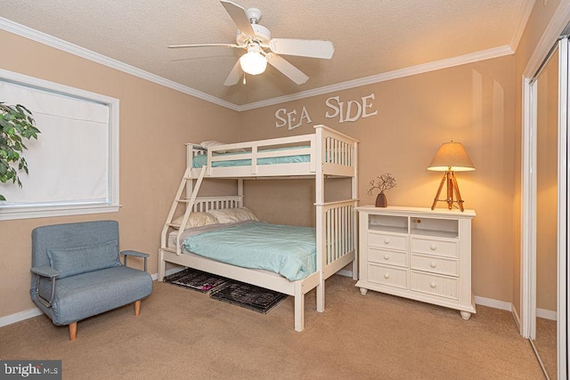 carpeted bedroom with crown molding, ceiling fan, and a textured ceiling