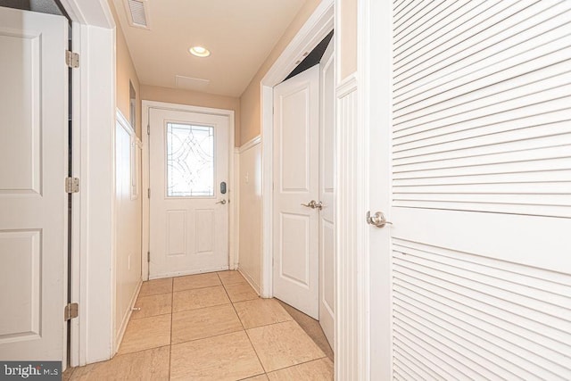 doorway to outside with light tile patterned floors