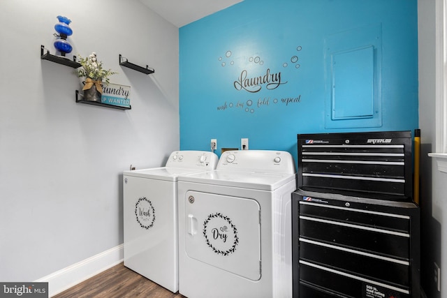 laundry room featuring dark hardwood / wood-style floors, electric panel, and washer and dryer