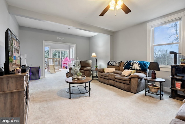 living room featuring light carpet and ceiling fan