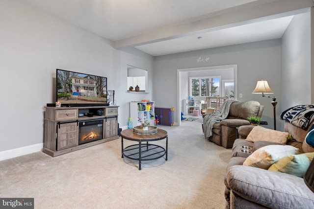 living room featuring beamed ceiling and light carpet