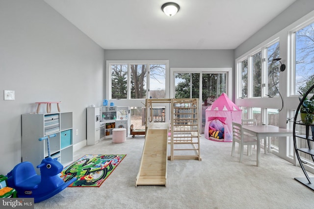 recreation room with light colored carpet