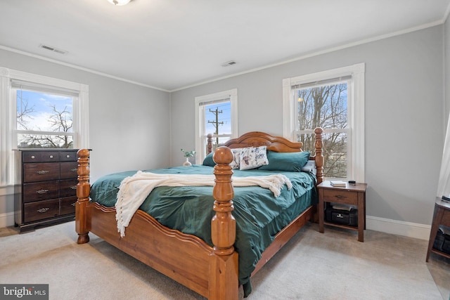 bedroom with multiple windows, crown molding, and light colored carpet