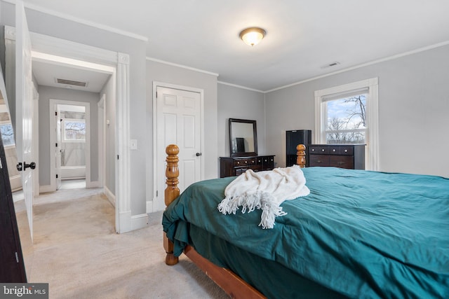 bedroom featuring ornamental molding and light colored carpet