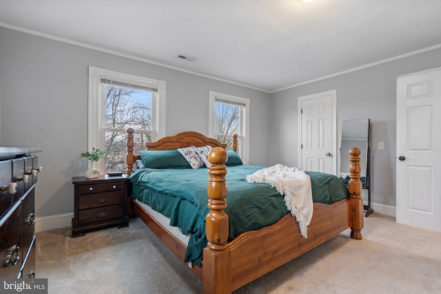 bedroom with ornamental molding and light colored carpet