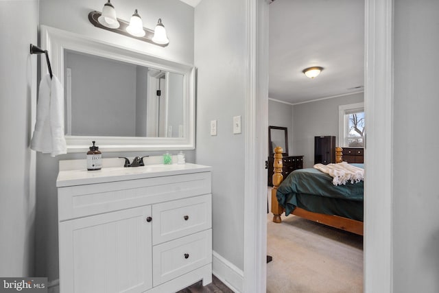 bathroom with crown molding and vanity