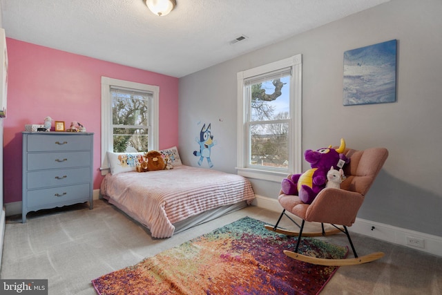 carpeted bedroom featuring a textured ceiling