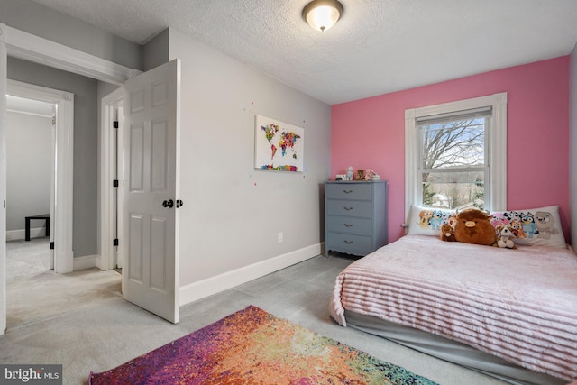 carpeted bedroom featuring a textured ceiling