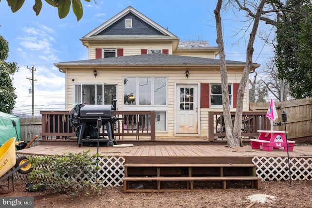 rear view of house with a wooden deck