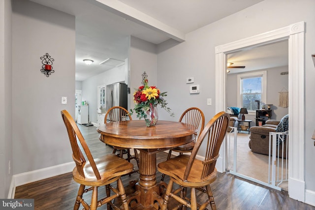 dining space with dark hardwood / wood-style flooring