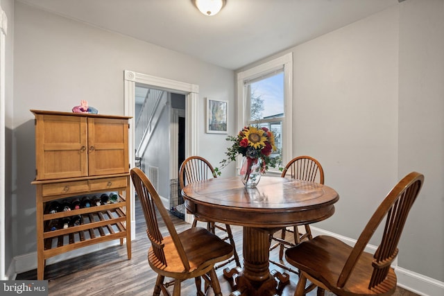 dining space with dark hardwood / wood-style flooring