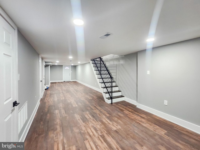 basement with dark hardwood / wood-style flooring