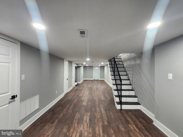 basement with dark hardwood / wood-style flooring