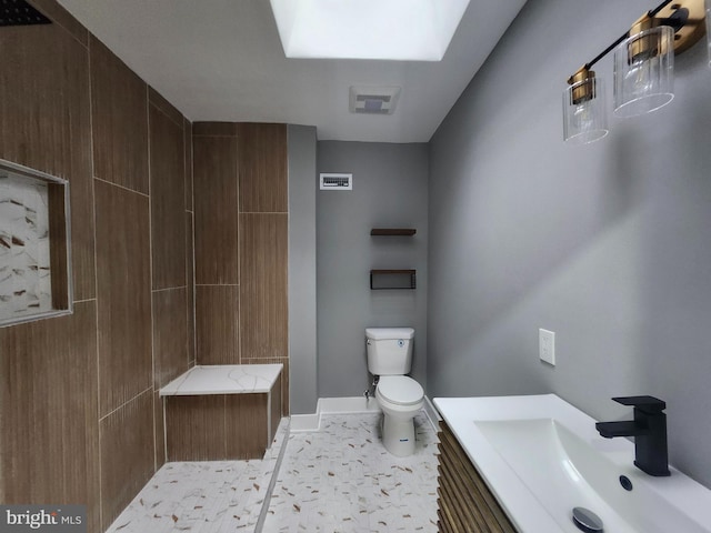 bathroom with tile patterned floors, vanity, and toilet