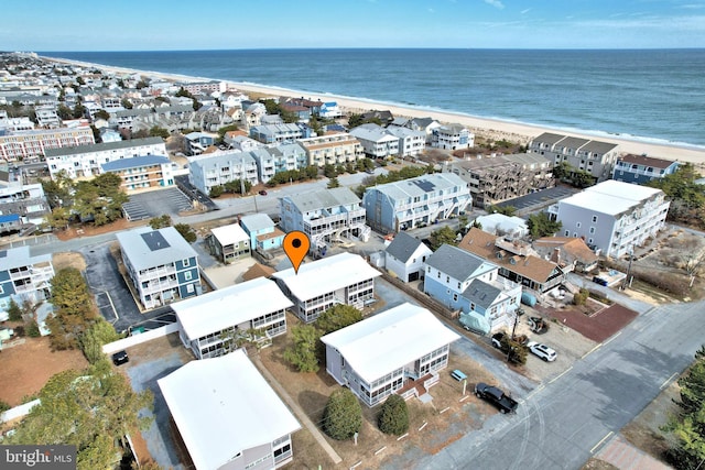 drone / aerial view featuring a water view and a view of the beach