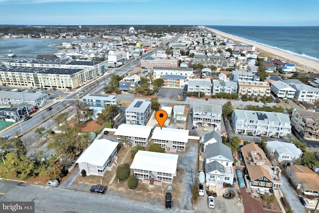 bird's eye view with a water view and a beach view