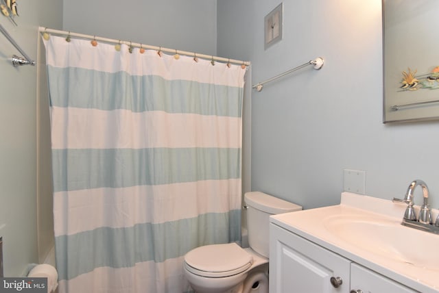 bathroom featuring vanity, toilet, and a shower with shower curtain