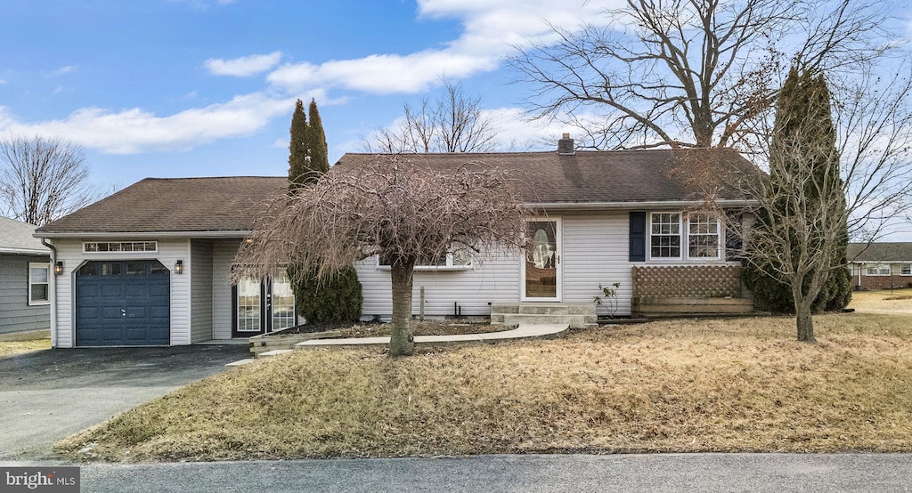 single story home featuring a garage