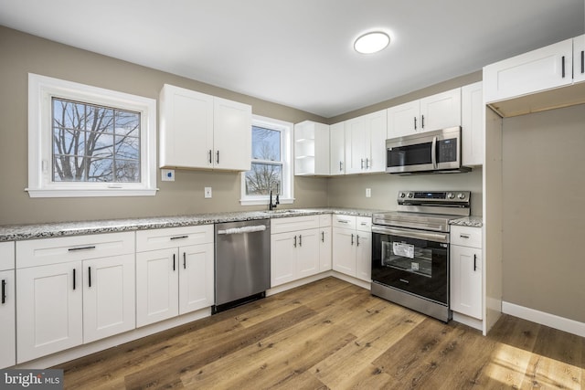 kitchen featuring sink, white cabinets, and appliances with stainless steel finishes