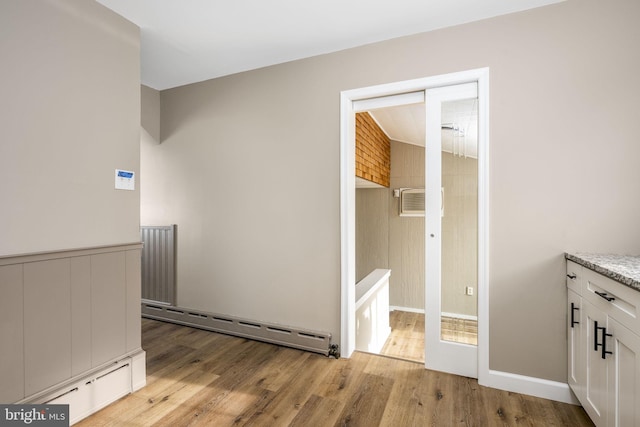 interior space featuring light hardwood / wood-style flooring and baseboard heating