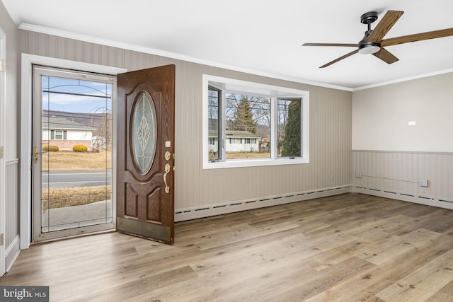 entrance foyer with crown molding, light hardwood / wood-style flooring, and ceiling fan