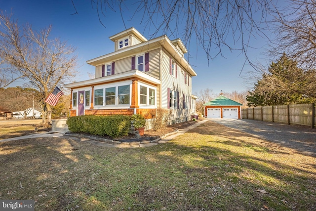 view of front facade featuring an outbuilding, a garage, and a front yard