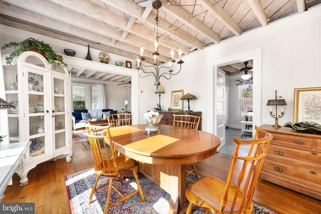 dining area with ceiling fan, dark wood-type flooring, wooden ceiling, and beam ceiling