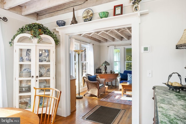 interior space with hardwood / wood-style floors and beamed ceiling