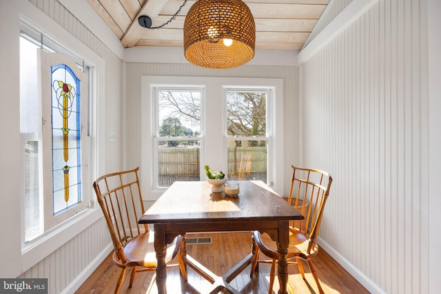 dining space featuring vaulted ceiling, wooden ceiling, and wood-type flooring