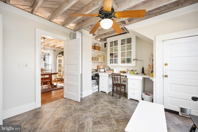 office area with ceiling fan with notable chandelier and beamed ceiling