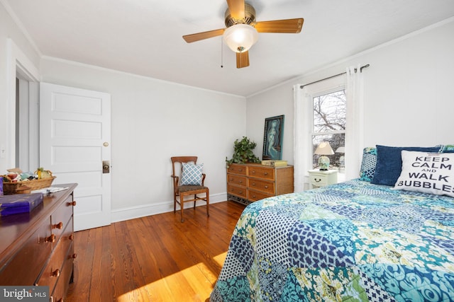 bedroom with crown molding, hardwood / wood-style floors, and ceiling fan