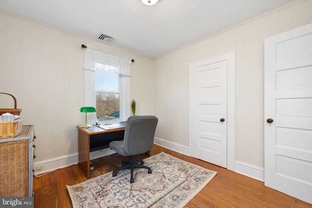 home office featuring crown molding and wood-type flooring