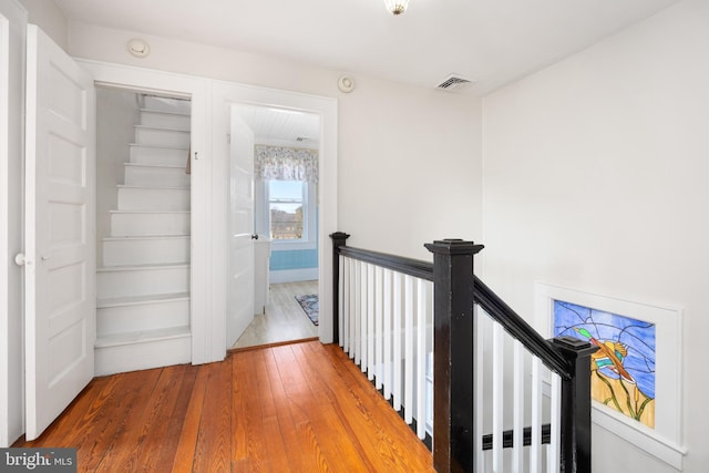 hall with hardwood / wood-style flooring