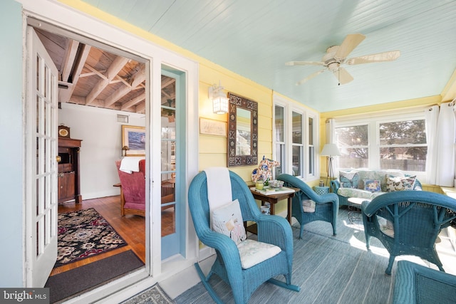 sunroom / solarium featuring wooden ceiling and ceiling fan