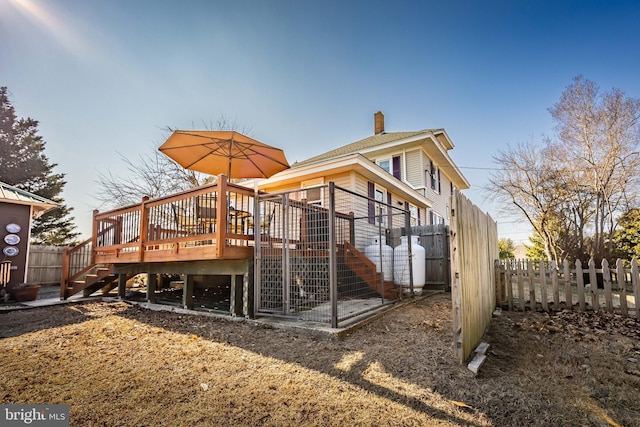 back of property with a wooden deck