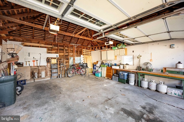 garage featuring a garage door opener and a workshop area