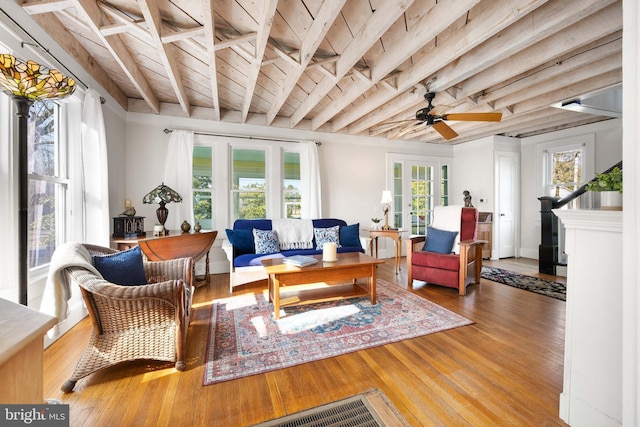 living room with beam ceiling, hardwood / wood-style floors, wood ceiling, and french doors