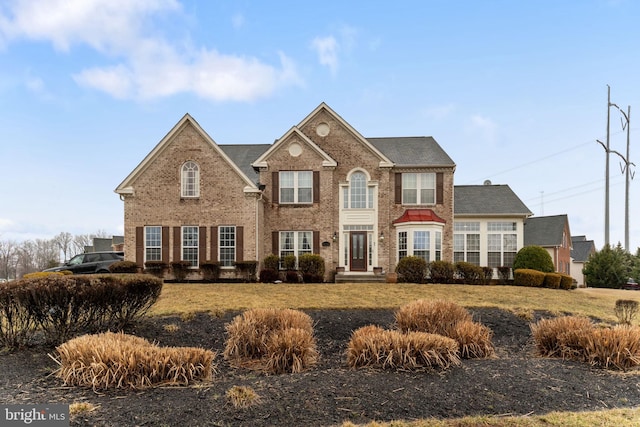 colonial inspired home featuring a front yard