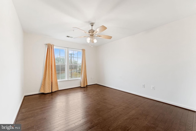 empty room featuring ceiling fan and dark hardwood / wood-style flooring