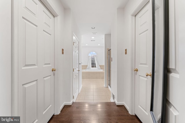 corridor featuring dark wood-type flooring