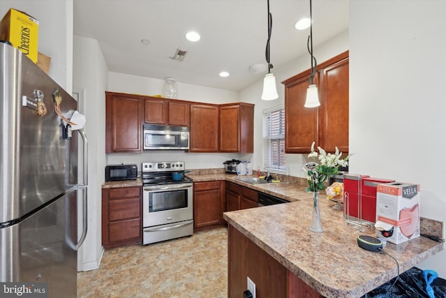 kitchen with appliances with stainless steel finishes, decorative light fixtures, kitchen peninsula, and sink