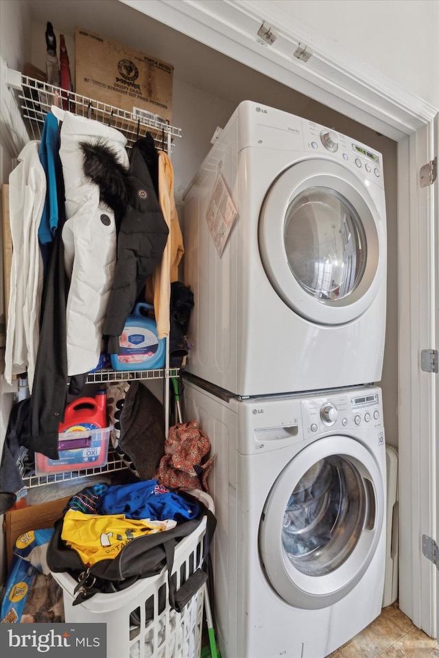 laundry area featuring stacked washer and clothes dryer