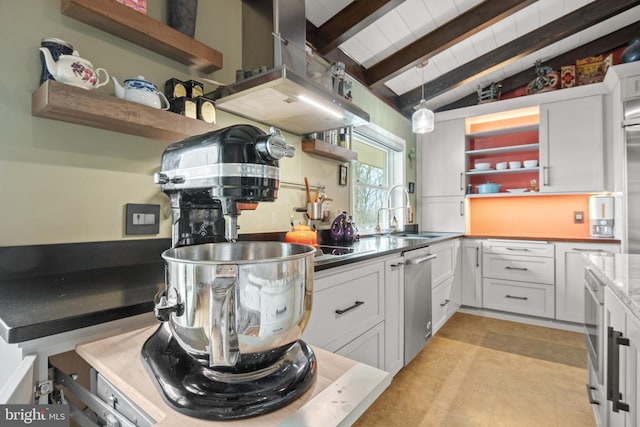 kitchen featuring lofted ceiling with beams, white cabinetry, sink, and decorative light fixtures