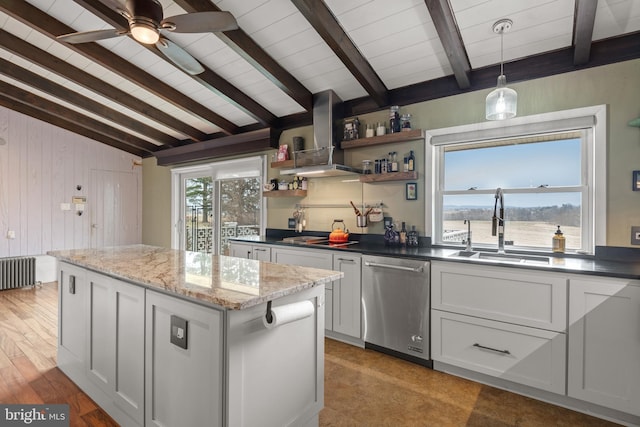 kitchen featuring radiator heating unit, dishwasher, sink, dark stone counters, and wall chimney exhaust hood