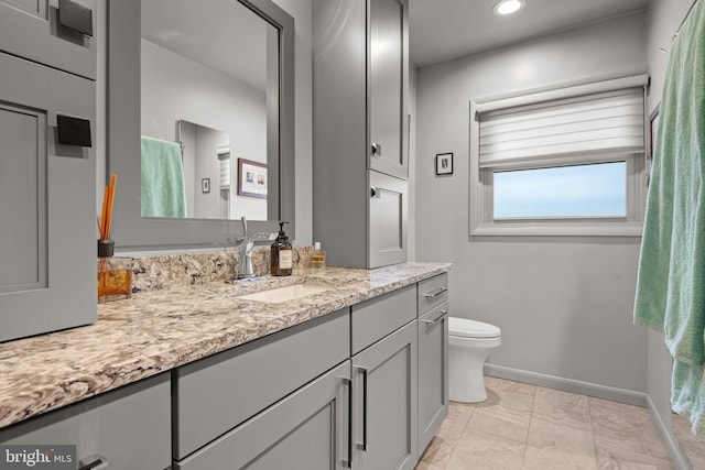 bathroom featuring vanity and toilet